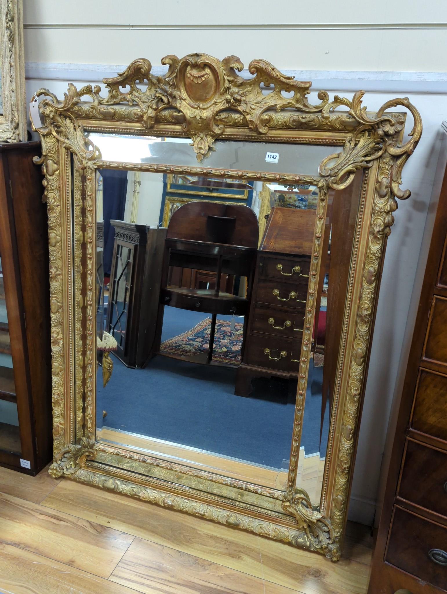 A large 19th century French gilt and gesso frame, bevel edged mirror with cushion margin, plated and C scroll, width 108cm, height 137cm